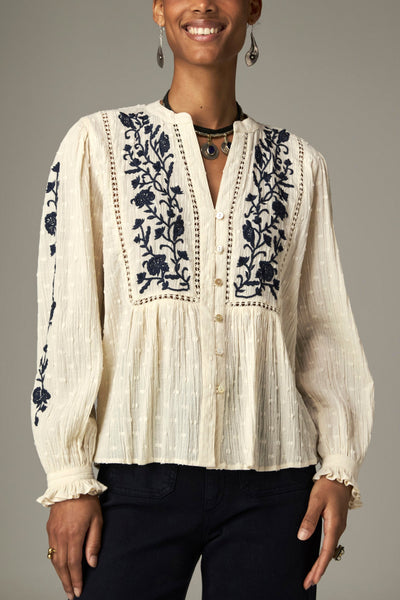 Morfeo Blouse in Blue Orchid, a cotton dobby blouse with V-neckline, embroidered yoke with lace inserts and embroidered sleeves