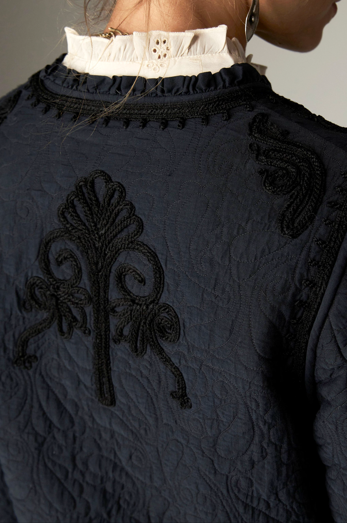 Paco Jacket in Ceniza, a cropped collarless viscose voile jacket with open front, embroidered trim and patch pockets
